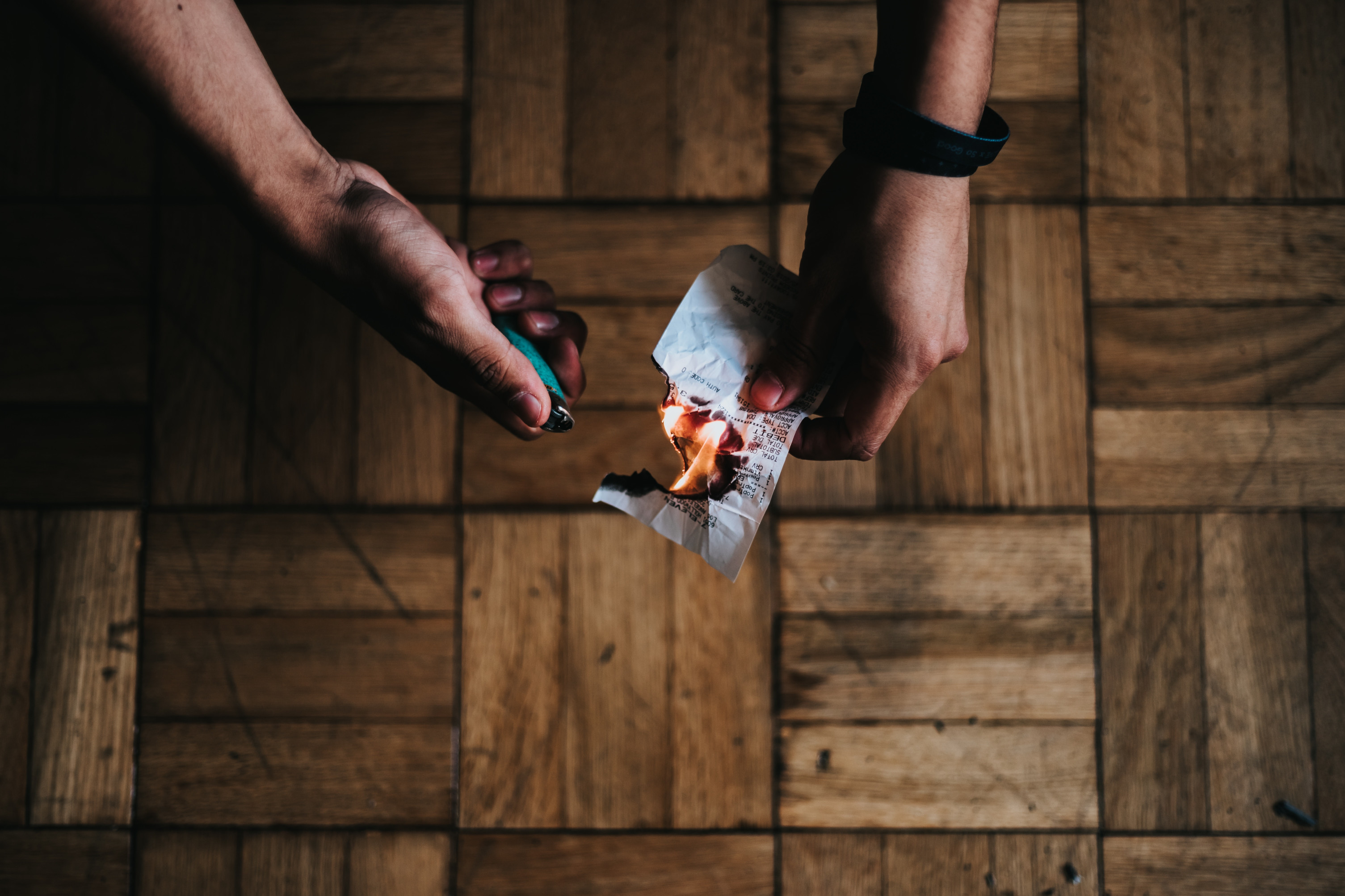 a picture showing a person burning a paper